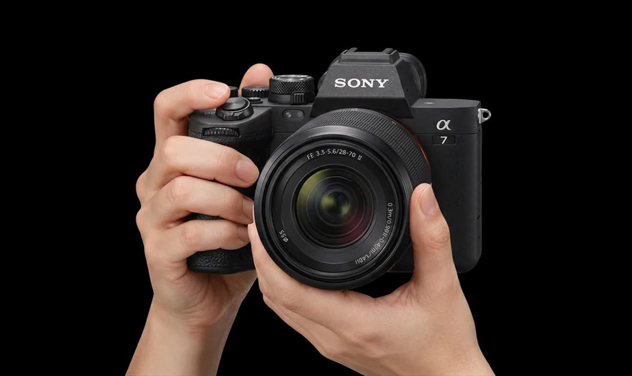 Two hands holding a Sony a7 IV camera up to shoot