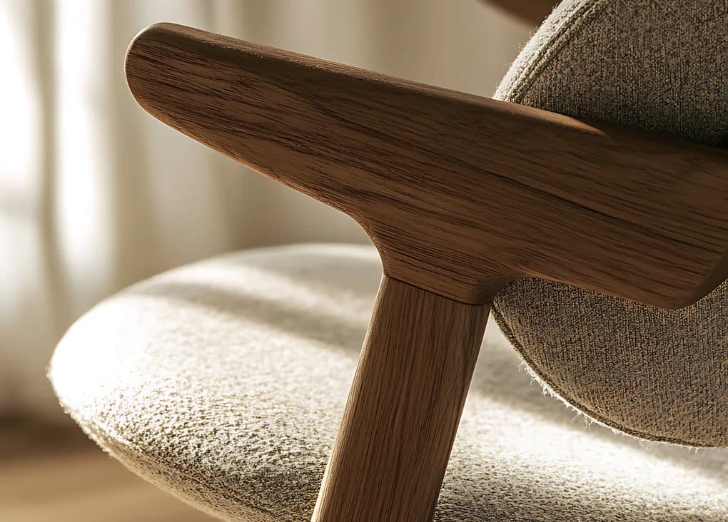 An oak armrest meeting a wool bouclé seat